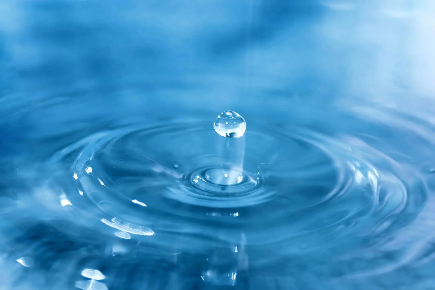 A water drop is shown in the air.